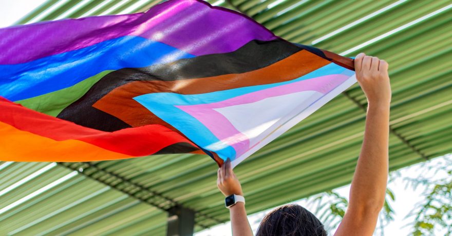 Female,Is,Holding,The,Gay,Rainbow,Flag.,Progress,Pride,Flag.