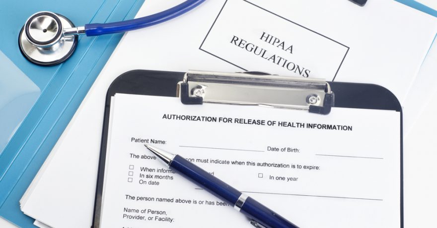 image of HIPAA forms on a Doctor’s desk.